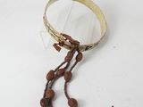 an image of a bracelet with beads on a white surface