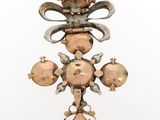 an image of a cross with pomegranates hanging from it ' s sides