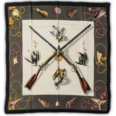 a close up of a square scarf with guns and birds on it