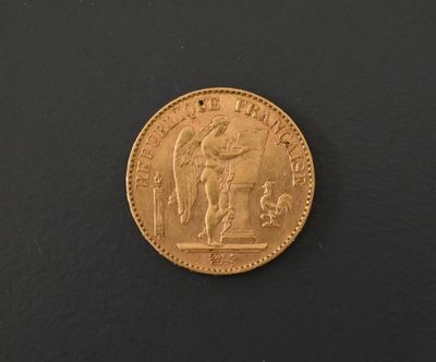 a close up of a gold coin on a black surface