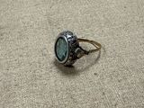 a ring that has a stone in it on the ground