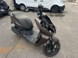 a scooter that is parked in a parking lot