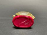 a close up of a red watch on a table