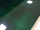 green glass counter top with three square lights on it
