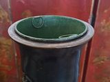 a black and green vase sitting on a table