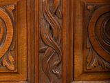 a close up of a wooden cabinet with a marble top