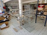 many cages with birds inside of them in a room