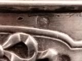 a close up of a metal object with a design on it