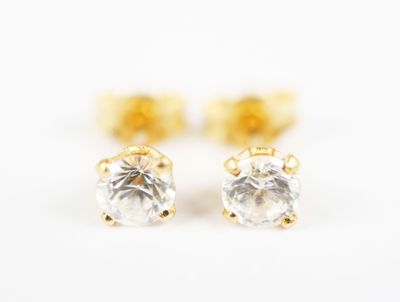 a pair of diamond stud earrings on a white background