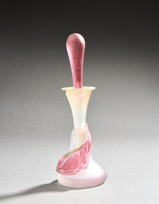 a glass vase with a pink and white design on it