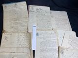 some old papers are piled on top of each other on a table