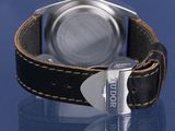 a close up of a watch on a blue surface