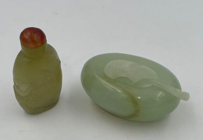 two green glass objects sitting next to each other on a white surface