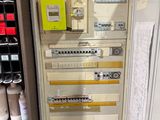 a cabinet that has a bunch of electrical wires on it
