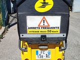 a scooter that is parked in front of a building