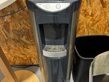 a water dispenser in the corner of a room