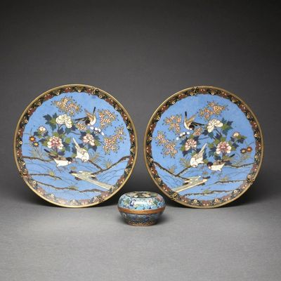 pair of blue and gold plates with birds and flowers on them