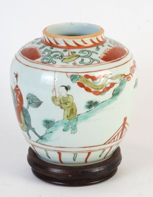 a vase that has a painting on it on a stand