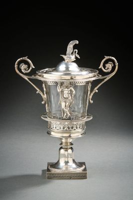 an antique silver plated cup on a stand with a bird on top