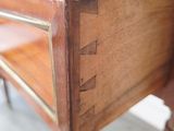 a close up of a wooden desk with a drawer on it