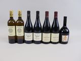 six bottles of wine are lined up in a row on a white surface