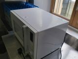 a white microwave sitting on a counter in a kitchen