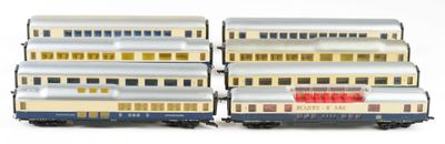 three silver and red train cars sitting next to each other on a white surface