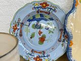 several plates and bowls are sitting on a table next to a glass of milk