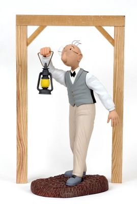 a figurine of a man holding a lantern in his hand