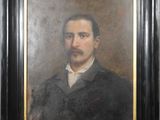portrait of a man with a mustache in a black frame
