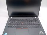 the laptop is open on a white surface with a black keyboard