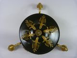 a black and gold plate with gold decorations on it
