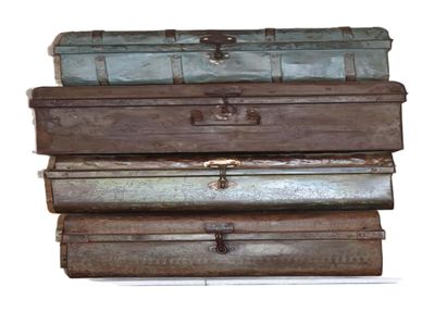 four suitcases stacked on top of each other on a white surface