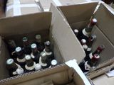 many bottles of beer in a cardboard box on the floor