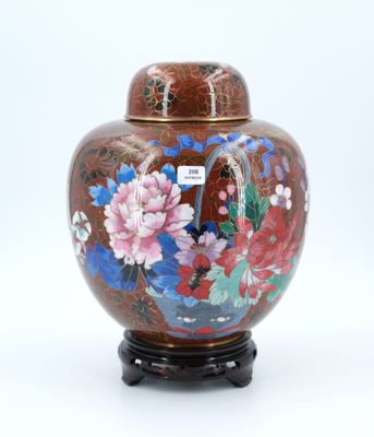 a vase with a lid that has flowers painted on it