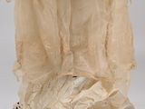 a woman ' s dress with a large ruffled skirt on a mannequin base