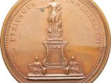 an image of a gold coin with a statue on top of it