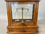 an old wooden case with a scale on top of it