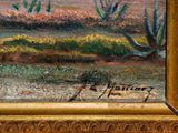 a painting of a desert scene in a gold frame