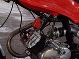 a red motorcycle that is parked in a garage