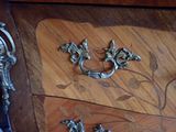 a wooden table with a metal handle and a drawer on it