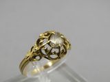 a close up of a gold ring on a clear surface