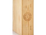 a wooden box with a wine bottle inside of it on a white surface