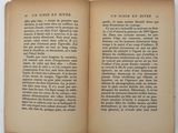 an open book on a white table with a picture of a cat