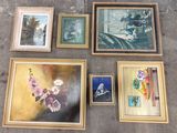 many framed pictures of flowers and vases on the floor