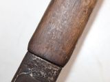 a close up of a knife with a wooden handle