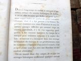 an old book that is open on a wooden table