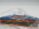 a pile of colored pencils wrapped in a plastic bag
