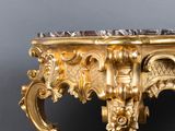 a gold table with a marble top on it