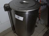 a trash can with a sink in the corner of the room